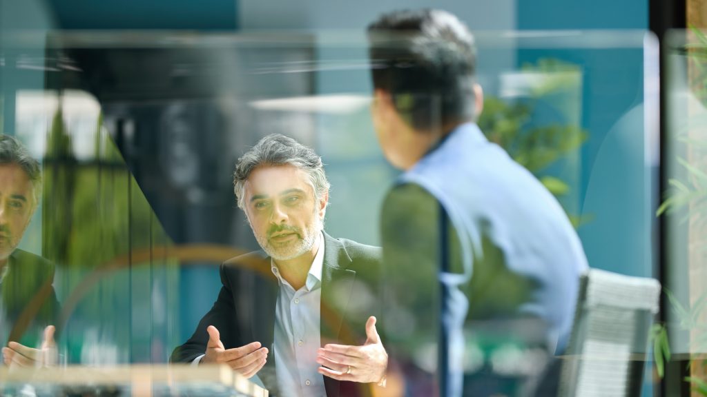 Board Service: The Best Time to Join Is Before You Retire An older board member talks during a board meeting.