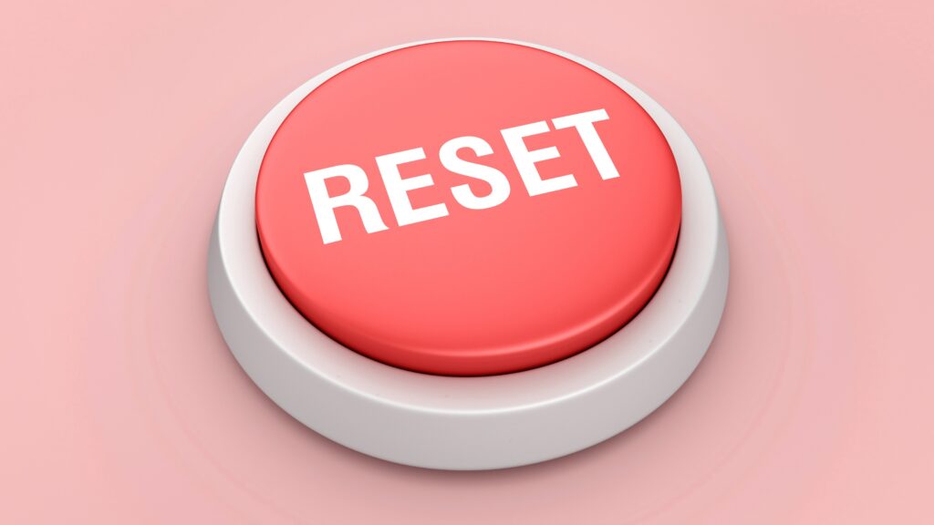 Financial Reset: A Simple Plan to Get Control of Your Money A red reset button against a pink background.