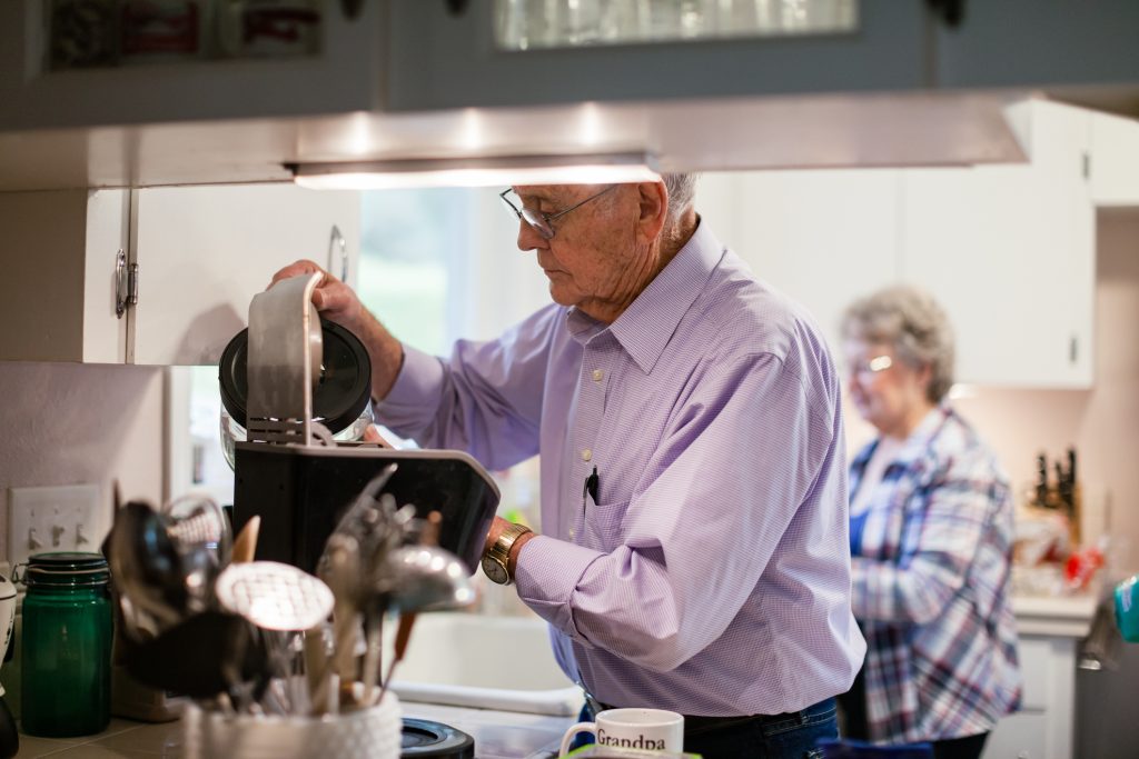 How to Plan for Aging in Place: Five Key Factors A couple in their 80s making coffee in their kitchen.