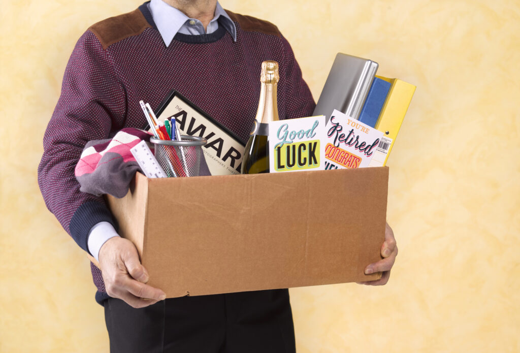 How Your Social Security Check Changes at Ages 62, 65, 66, 67 and 70 A senior man carrying a box of possessions after retiring