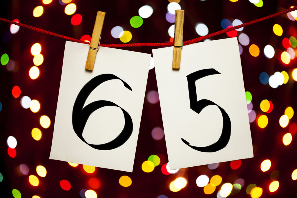 How the New $6,000 'Senior Bonus' Tax Deduction Works for 2025 the number 65 on clothespins hanging on a line