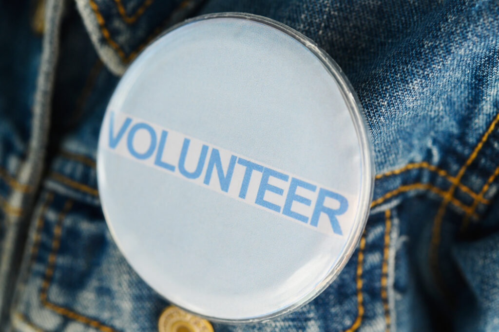 'Rich' Tricks to Volunteer and Donate in Retirement Volunteer pin on a jean jacket