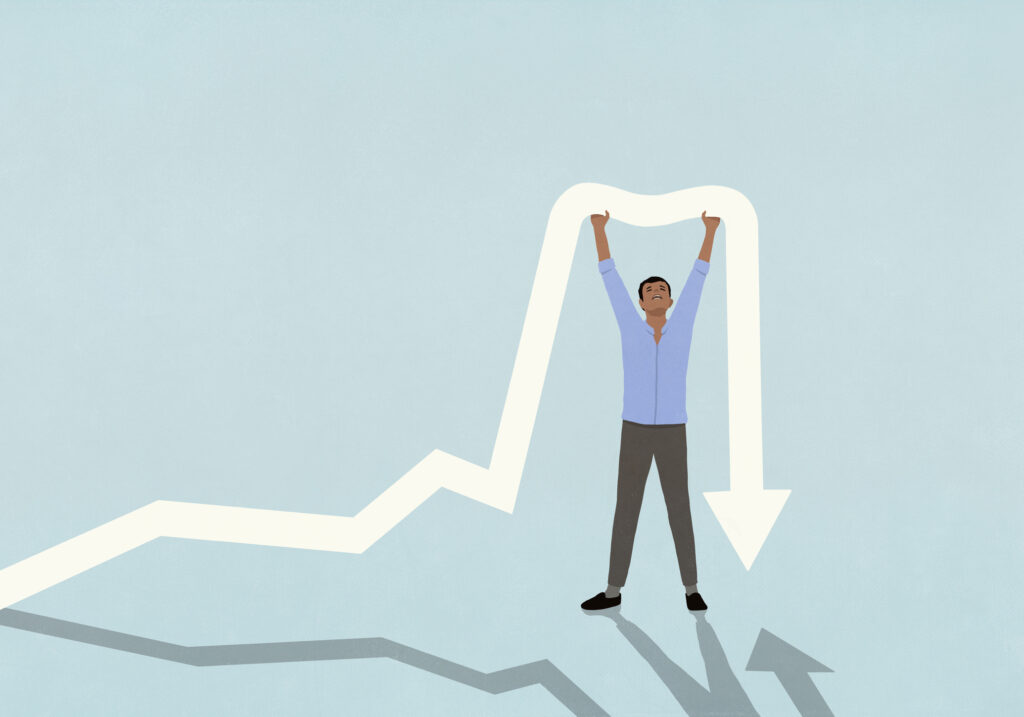 Man with arms raised holding up falling arrow