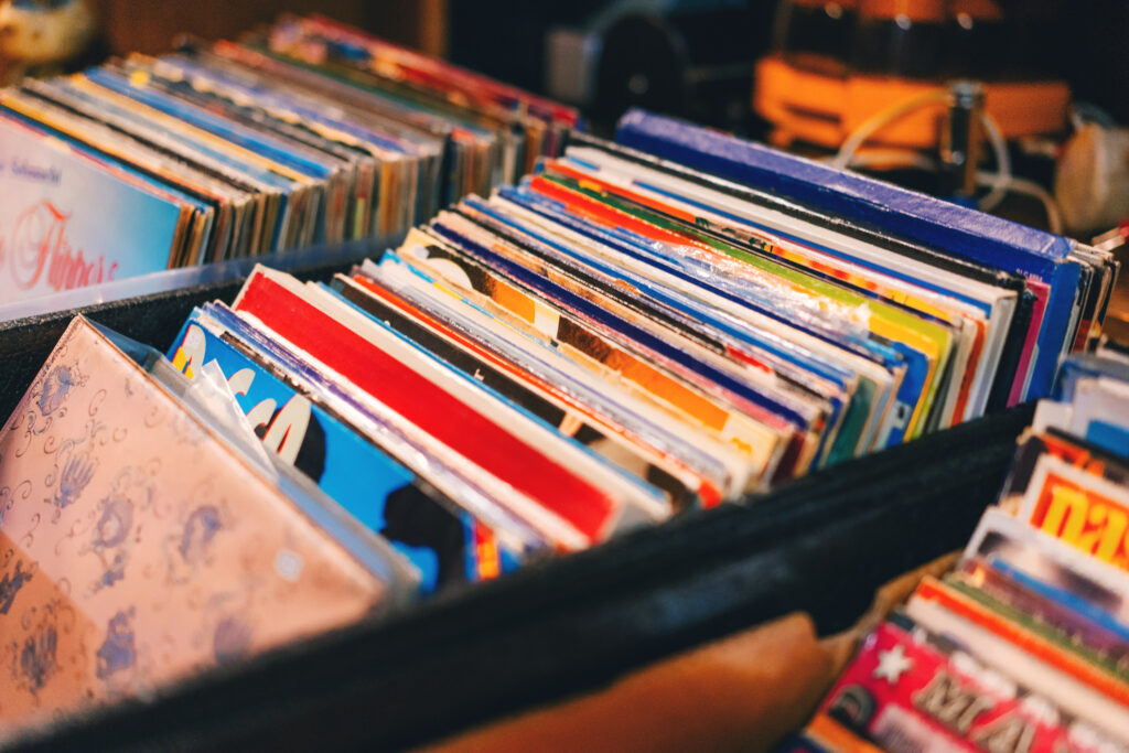 The 'Vinyl Rule' of Retirement: Plan for Two Sides in Your Next Act A view of colorful records in milk crate boxes, likely at a vintage record store.