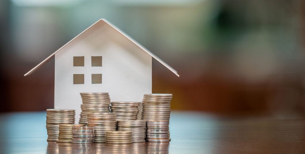 Could 50-Year Mortgages Actually Make Sense For Investors? house with coins to show heloc vs home equity loan concept