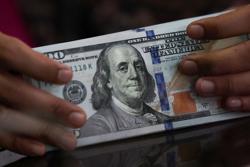 Dollar heads for modest weekly rise, balancing Fed outlook and US data