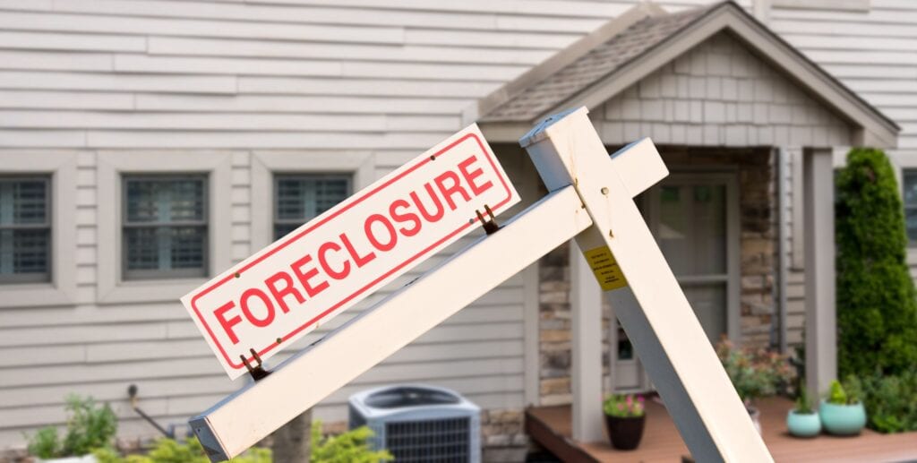 foreclosure sign in front of house
